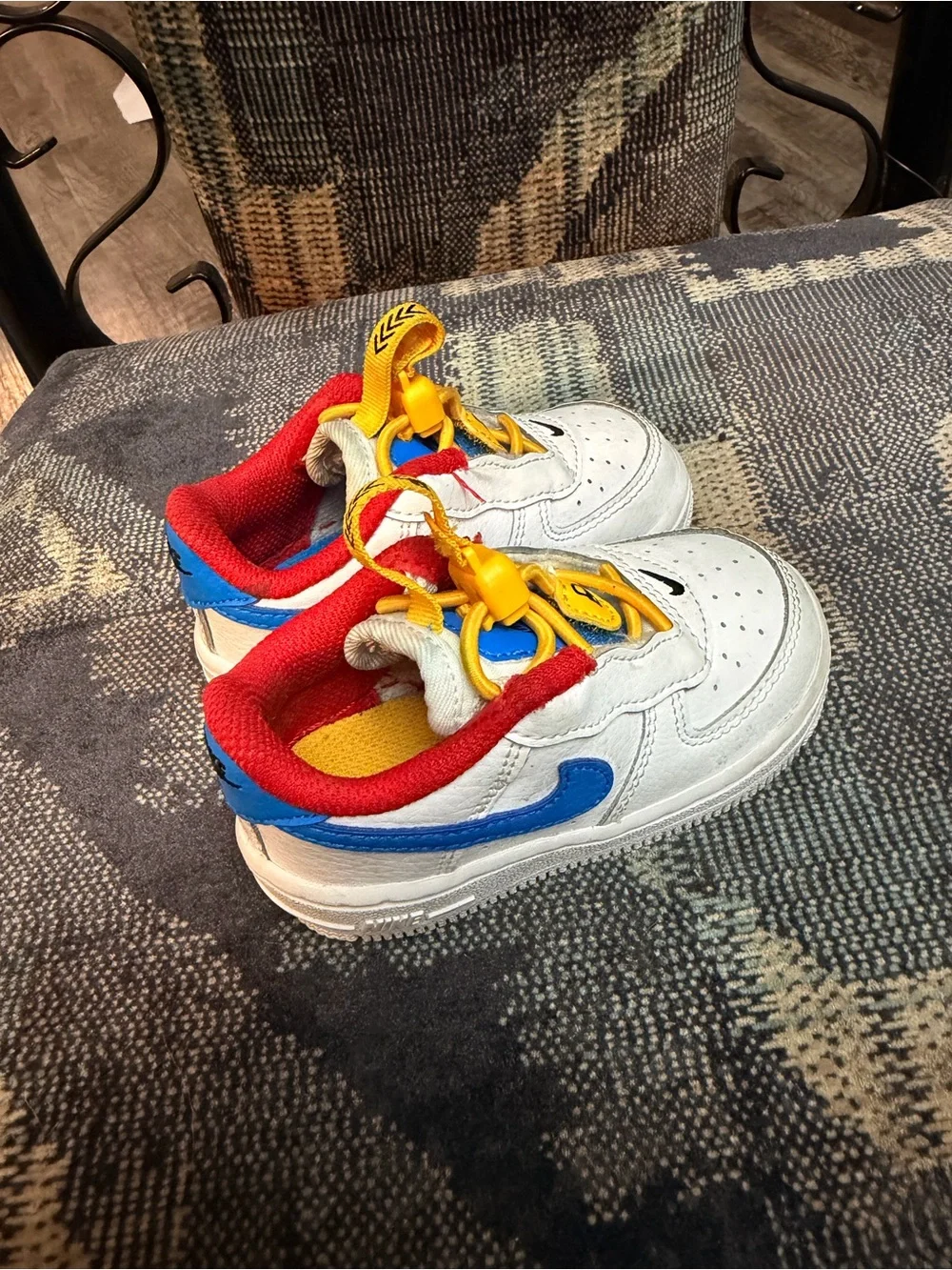Nike White Kids Sneakers with Red Lining, Yellow Laces & Blue Accents